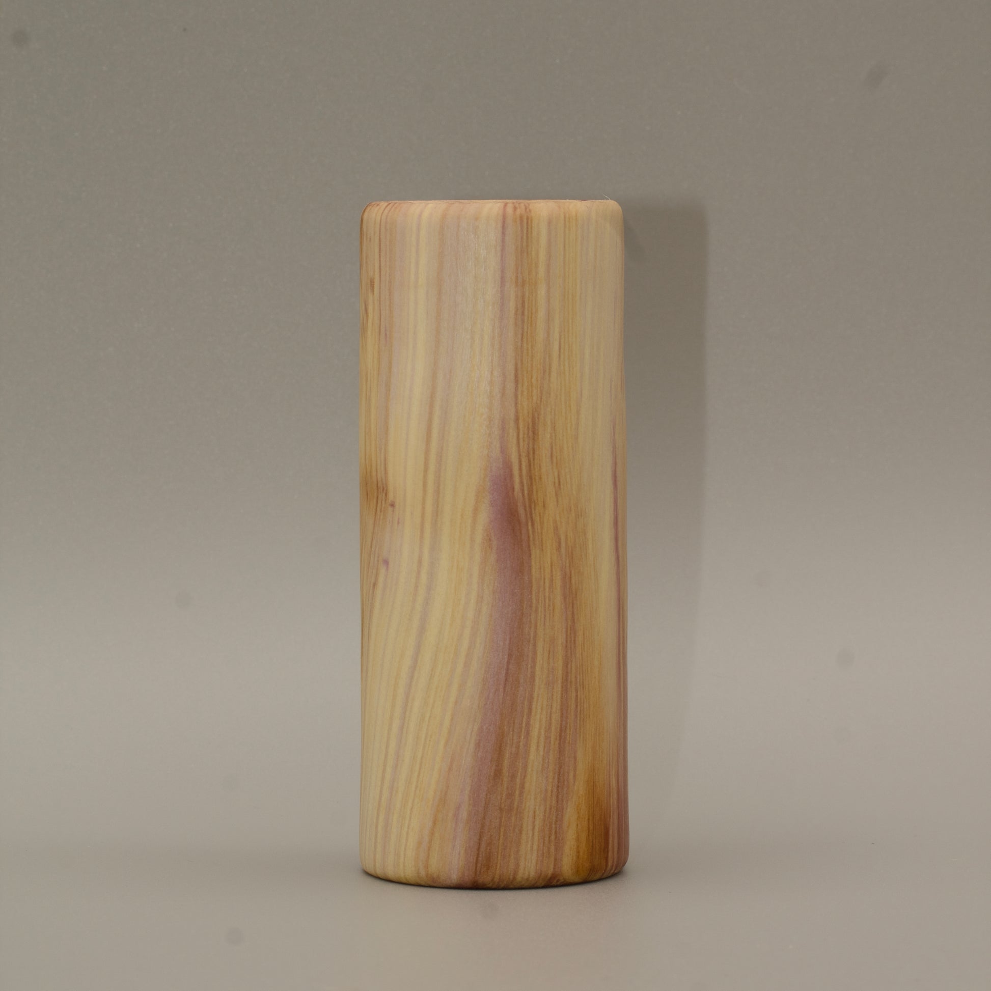 Tall rainbow colored aspen wood shot glass on white background
