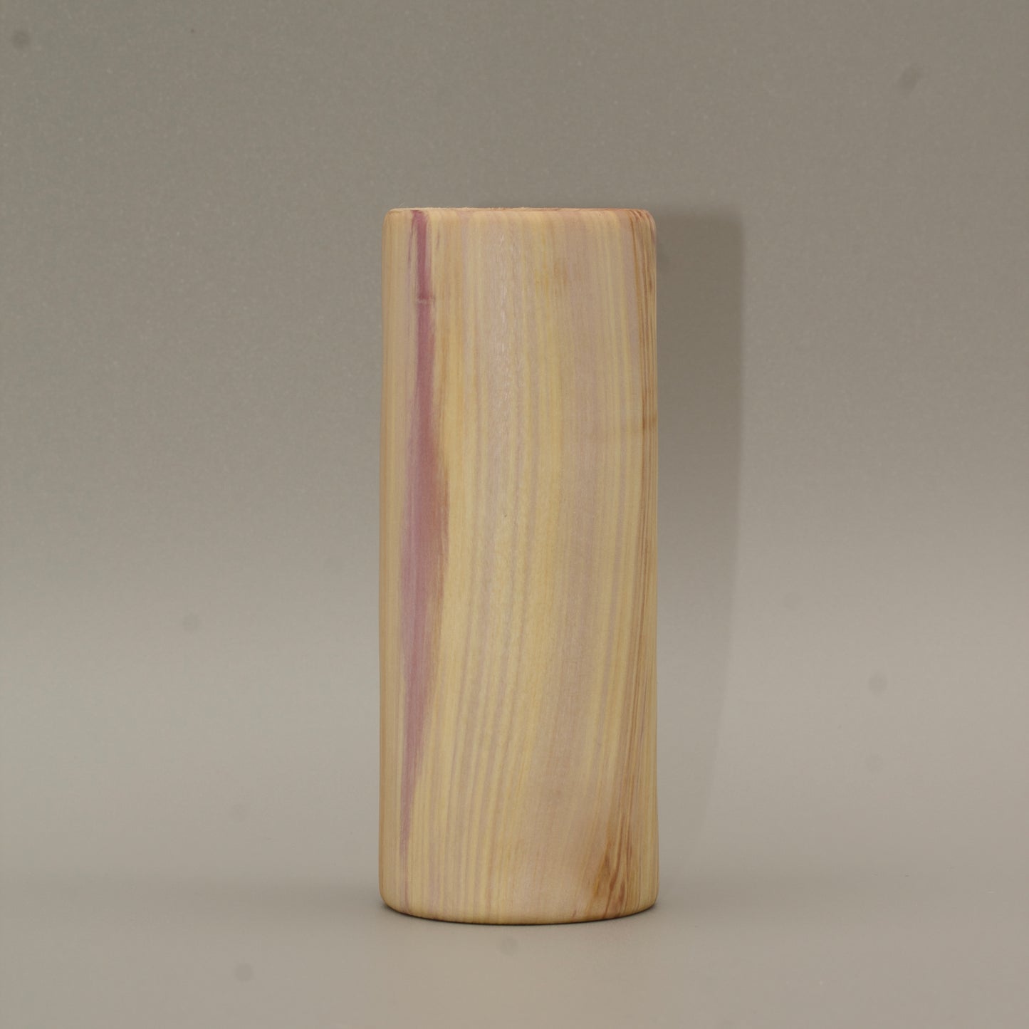 Tall rainbow colored aspen wood shot glass on white background