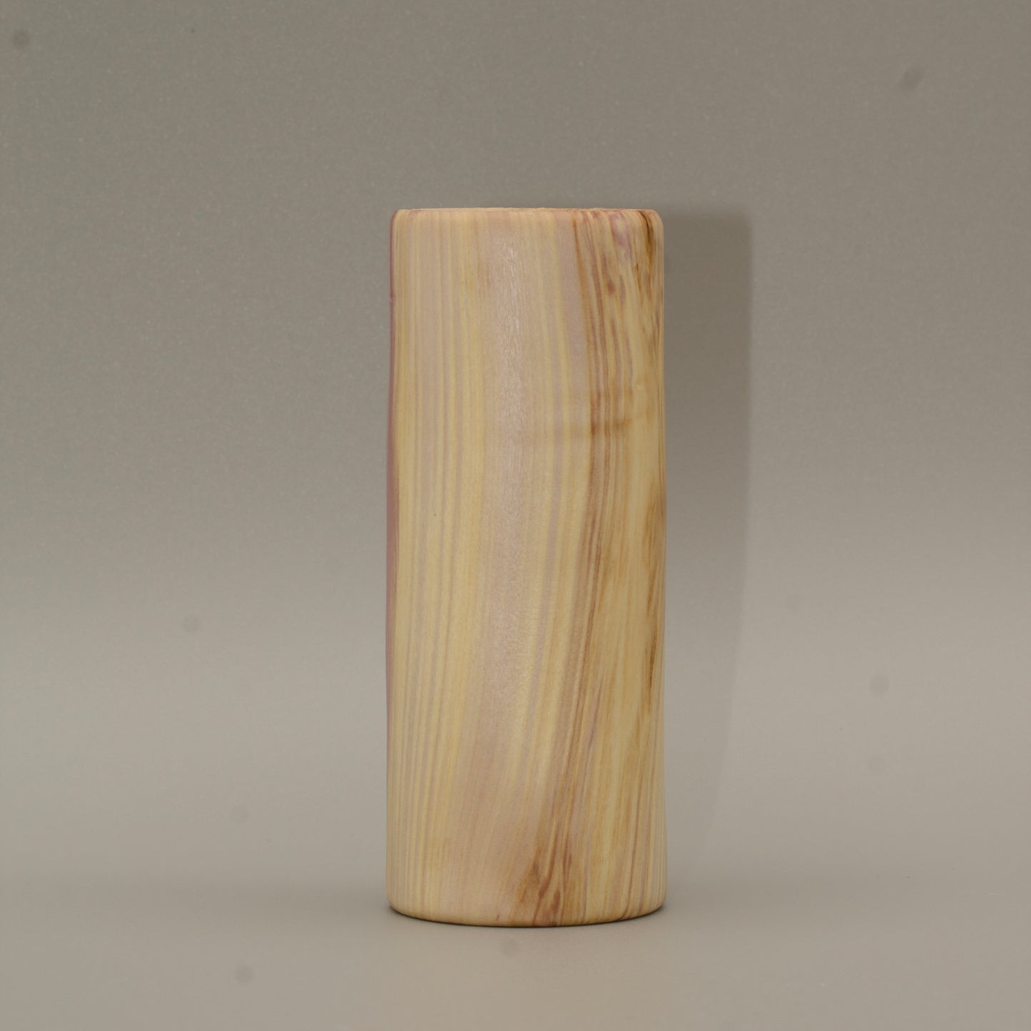 Tall rainbow colored aspen wood shot glass on white background