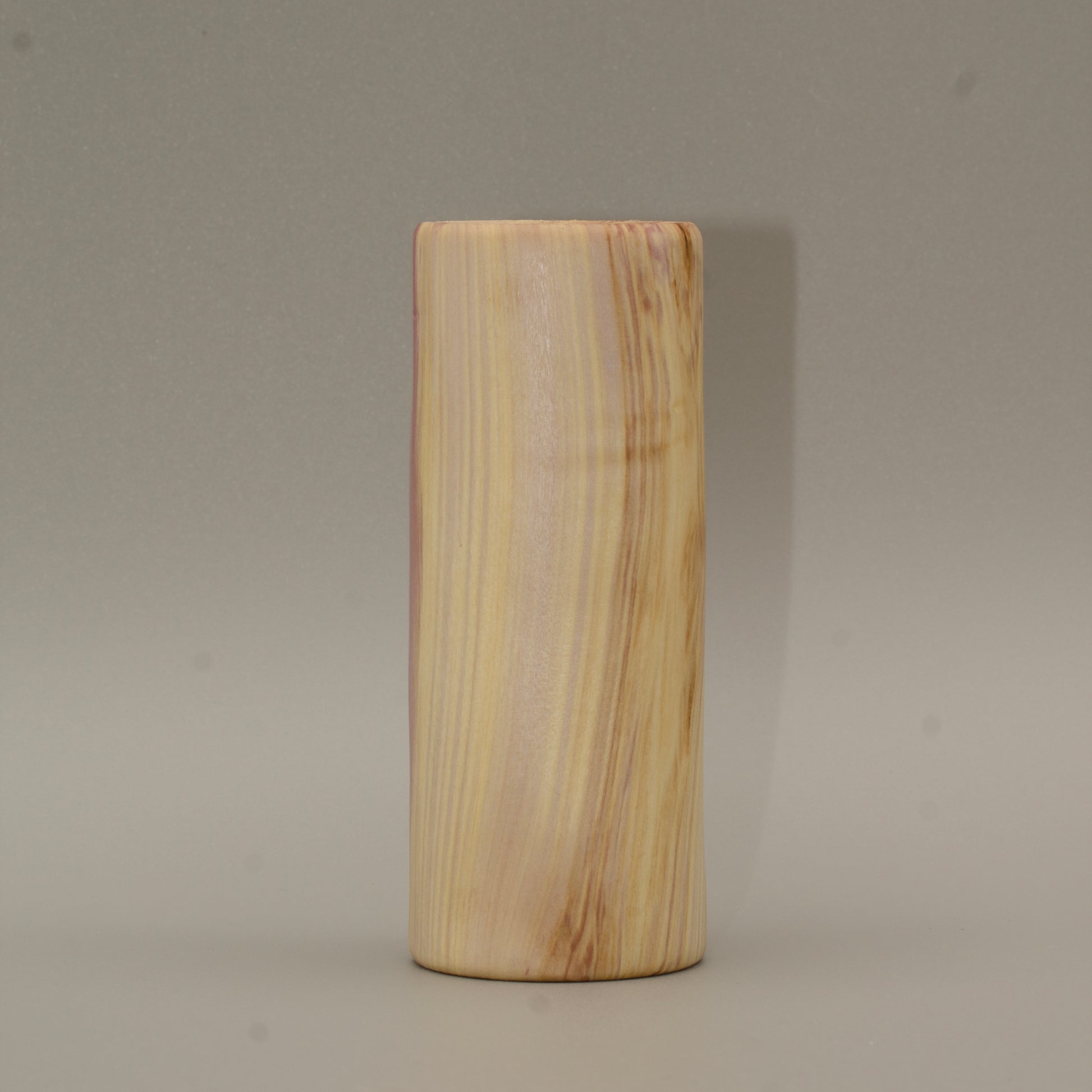 Tall rainbow colored aspen wood shot glass on white background