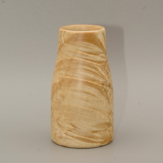 Giant box elder burl wood shot glass against white background