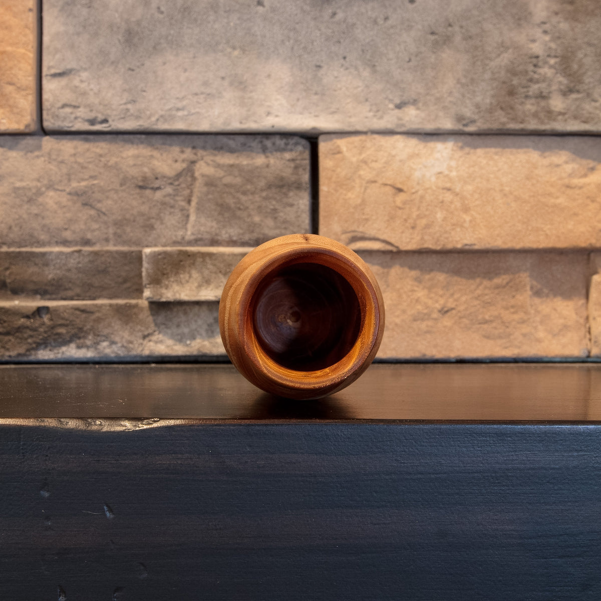 Opening view of Eòlas showing its rounded wooden rim and deep dark interior