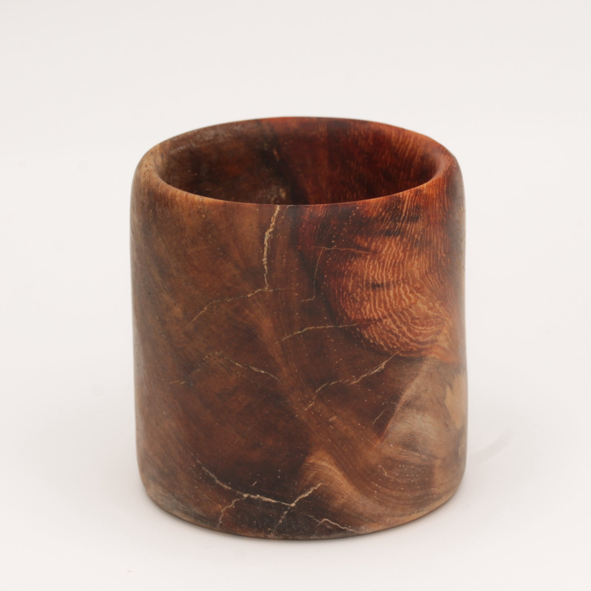 Amboyna burl shot glass against white background
