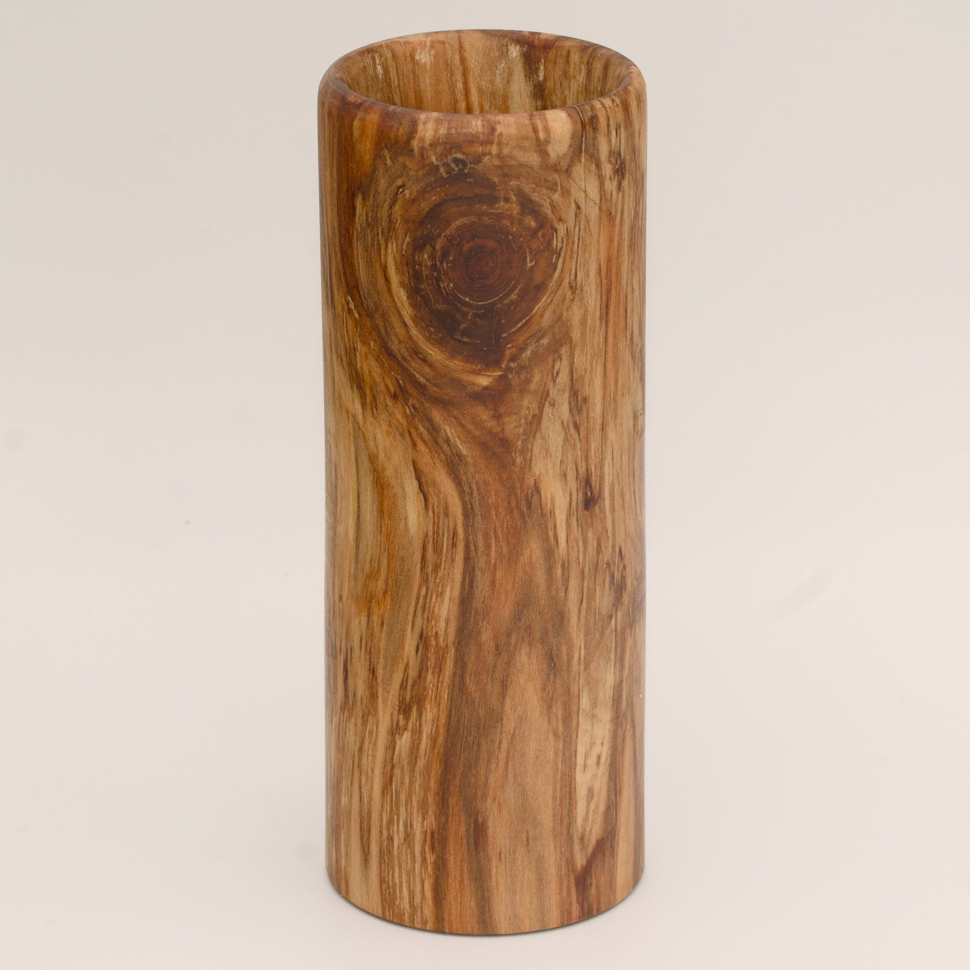 Plains cottonwood wood shot glass against white background