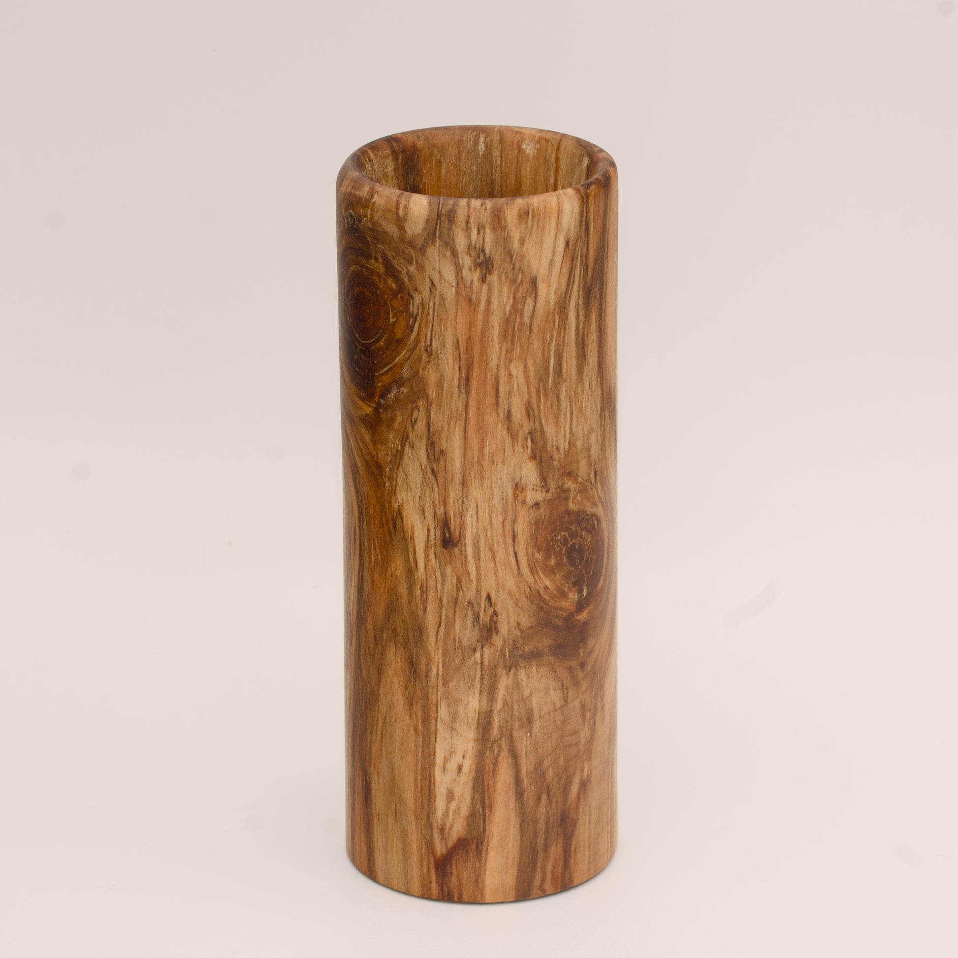 Plains cottonwood wood shot glass against white background