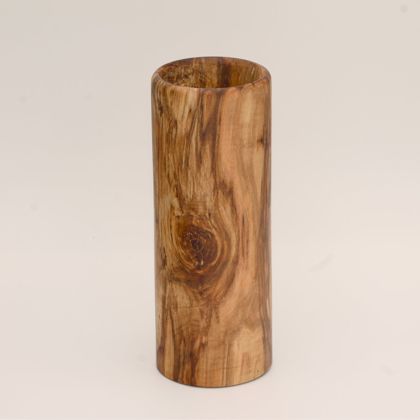 Plains cottonwood wood shot glass against white background