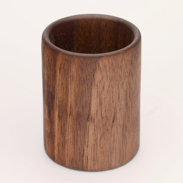Walnut wood shot glass against white background