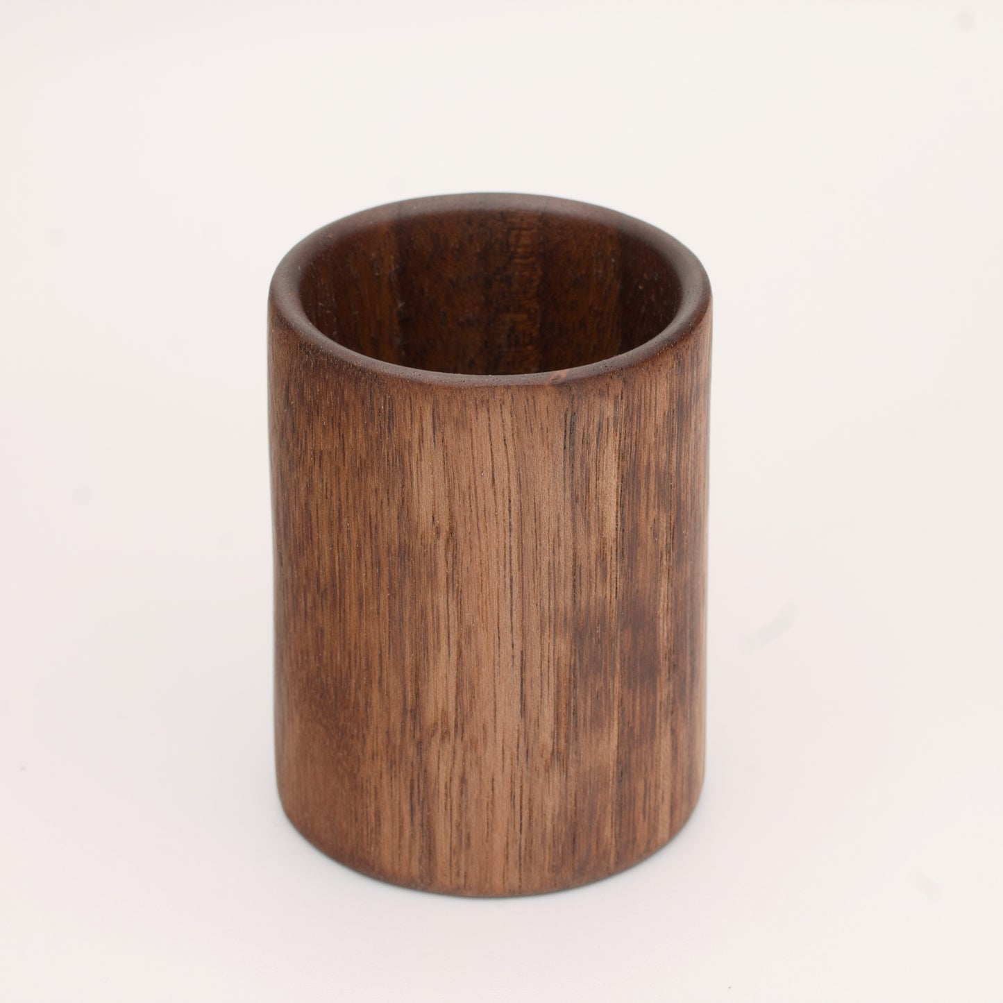 Walnut wood shot glass against white background