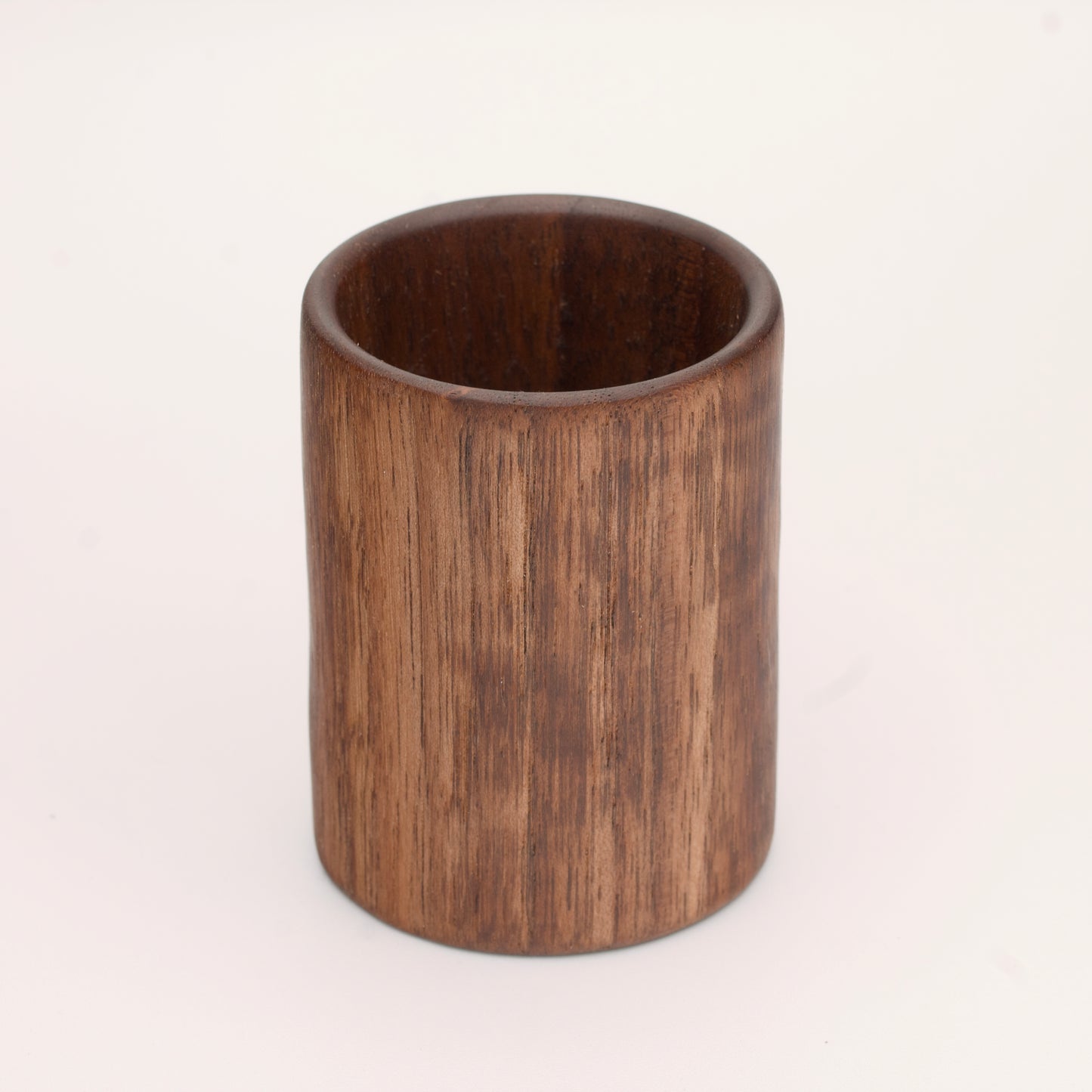 Walnut wood shot glass against white background