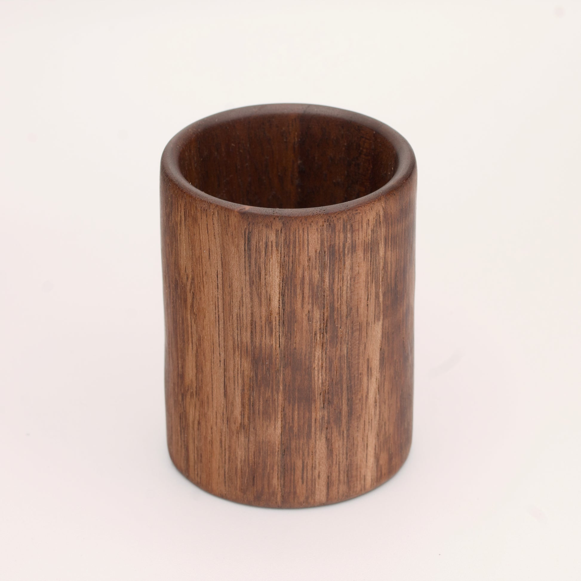 Walnut wood shot glass against white background