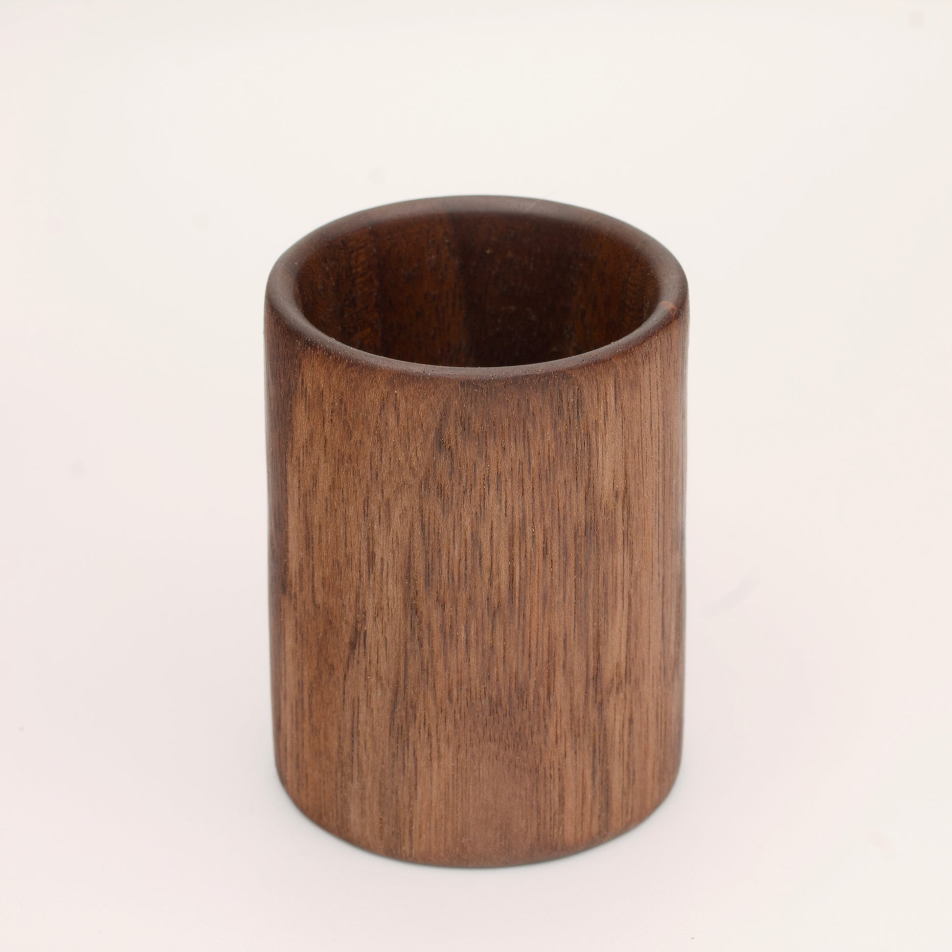 Walnut wood shot glass against white background