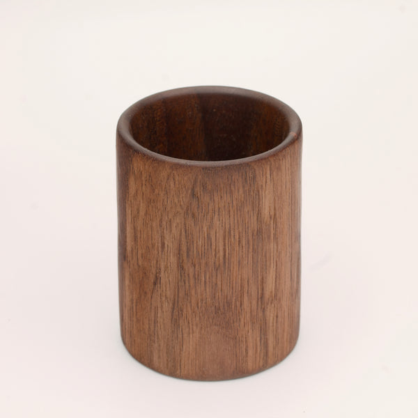 Walnut wood shot glass against white background