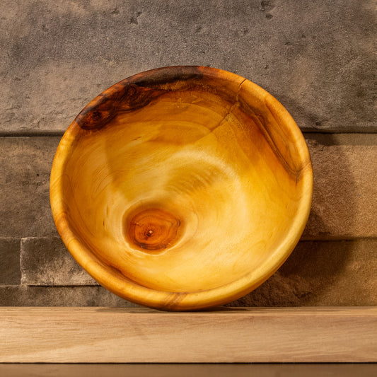 Interior view of The High Plains Vessel looking down into the bowl, showing a solid natural knot at the base and streaked grain along the rim