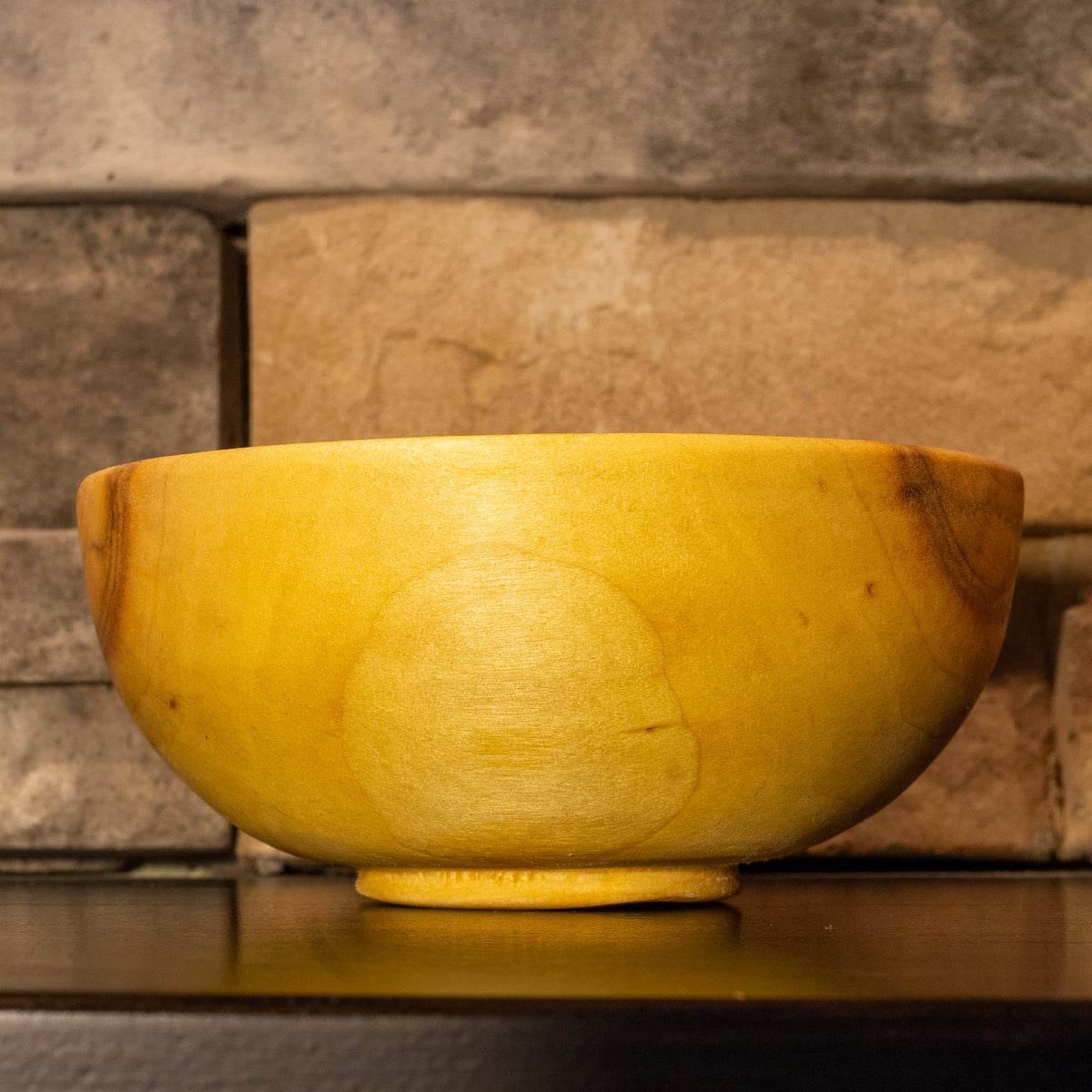 Side view of The High Plains Vessel showing warm golden grain with small natural mineral flecks