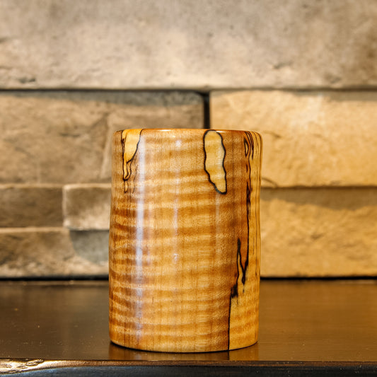 Spalted maple shot glass featuring pronounced curly figure and contrasting dark spalting.