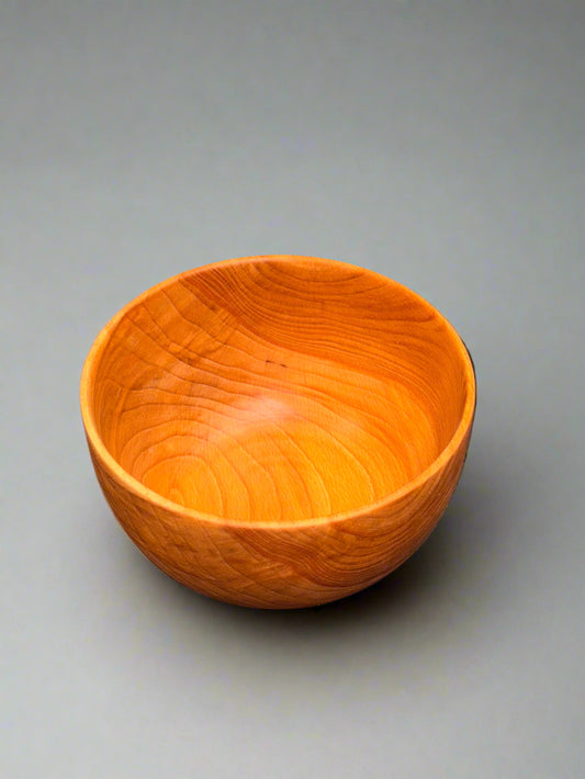 Wooden bowl on a gray surface