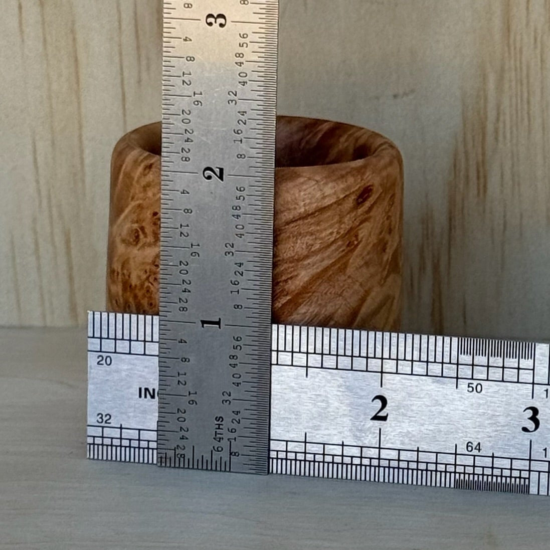 Maple burl shot glass with rulers showing it is approximately 2" x 2".
