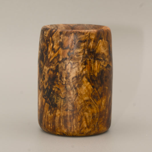 Amboyna burl striped wood shot glass against white background