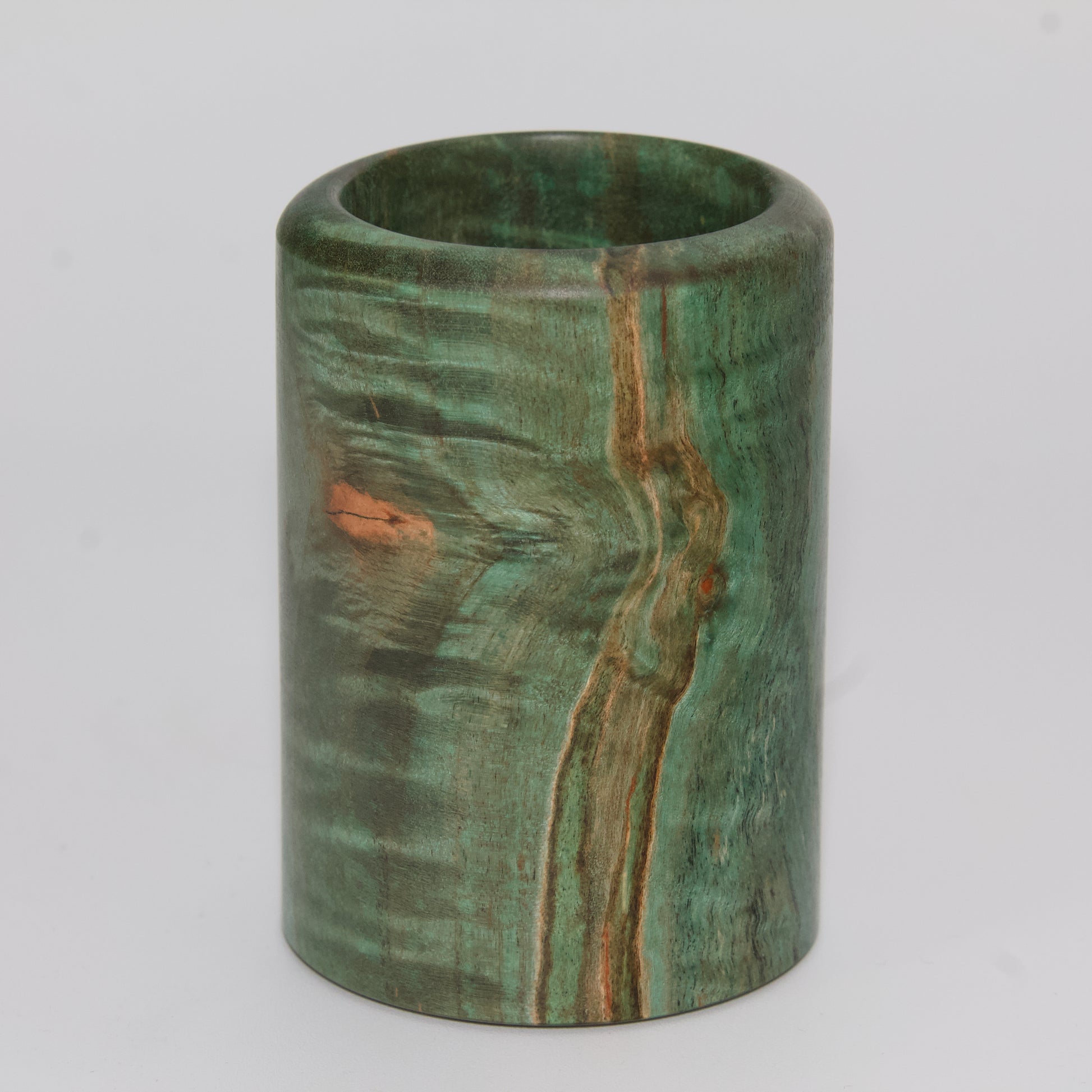 Green dyed curly spalted maple burl shot glass against white background