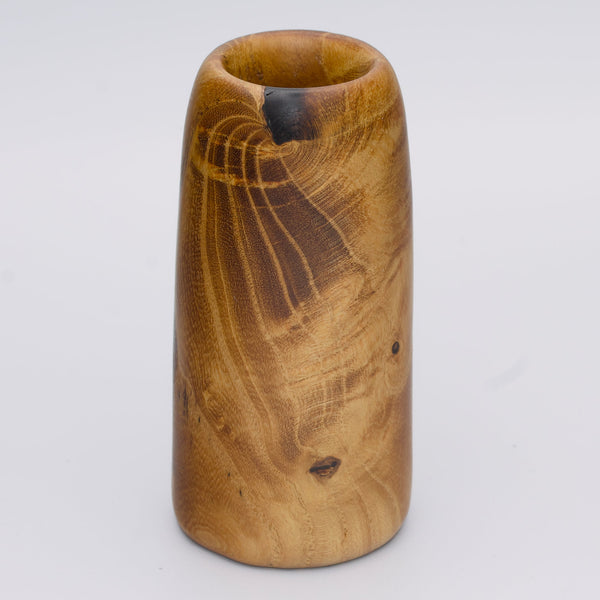 Stunning tall mulberry wood shot glass against white background