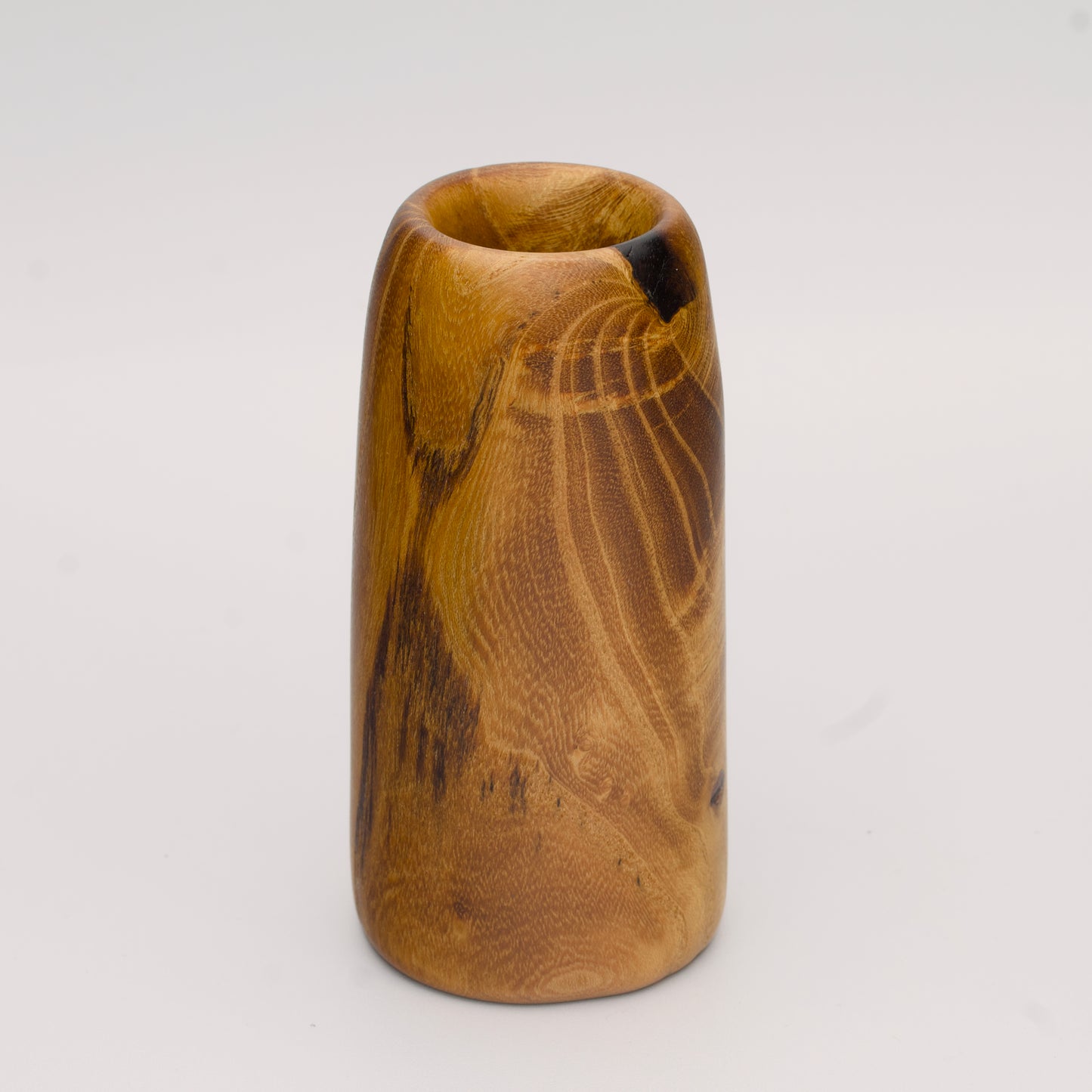 Stunning tall mulberry wood shot glass against white background