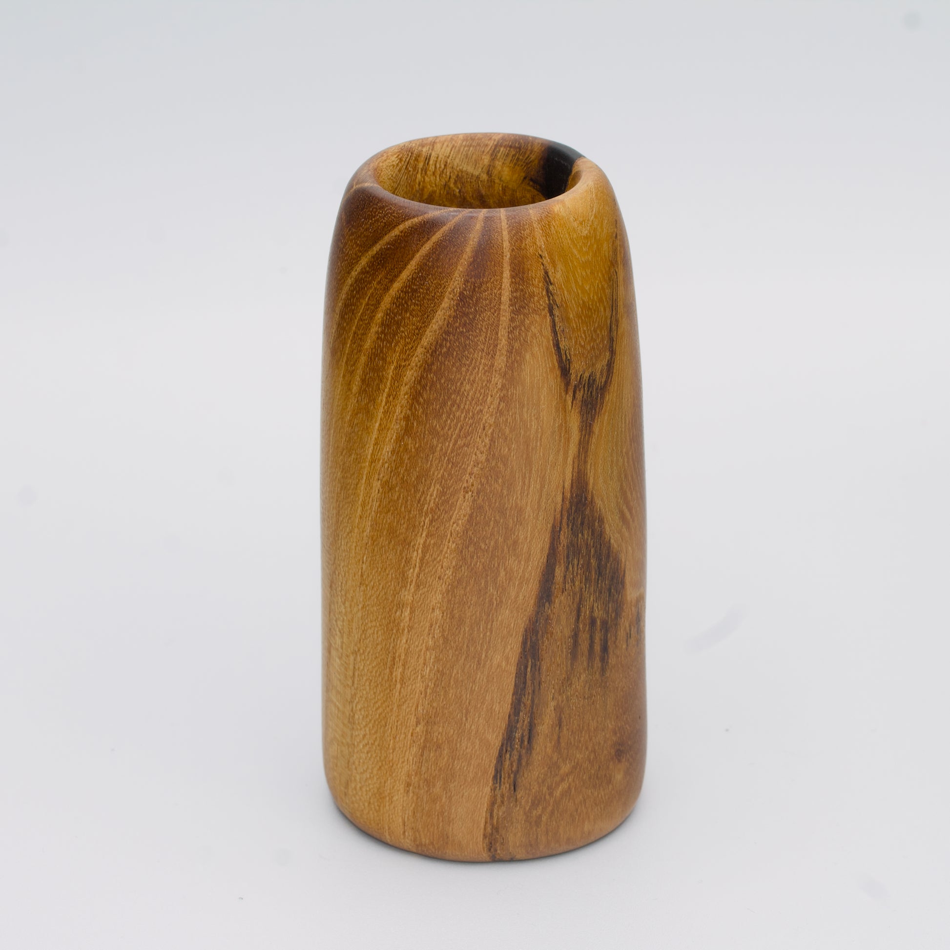 Stunning tall mulberry wood shot glass against white background