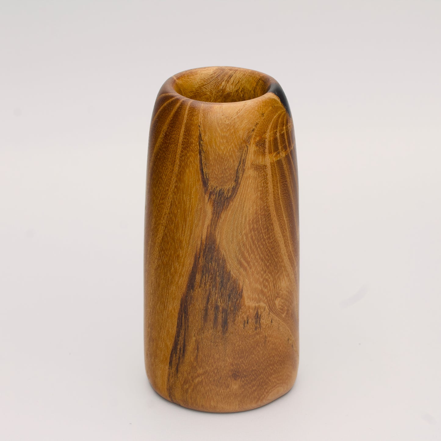 Stunning tall mulberry wood shot glass against white background