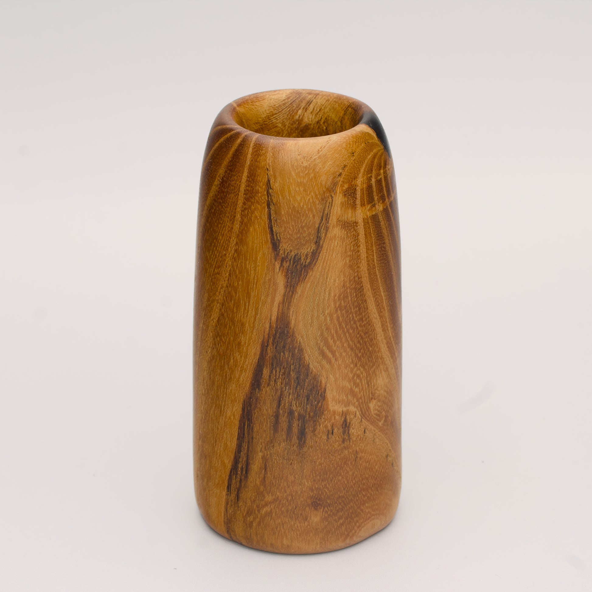 Stunning tall mulberry wood shot glass against white background