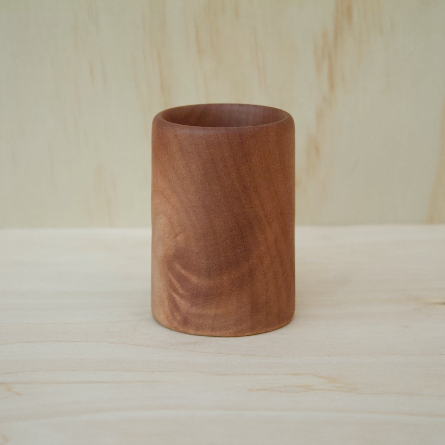 hand made wooden shot glass with golden brown tones 