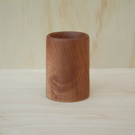 hand made wooden shot glass with golden brown tones 