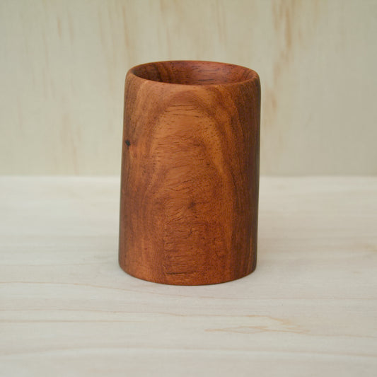 chestnut color wooden cup on a light wooden background