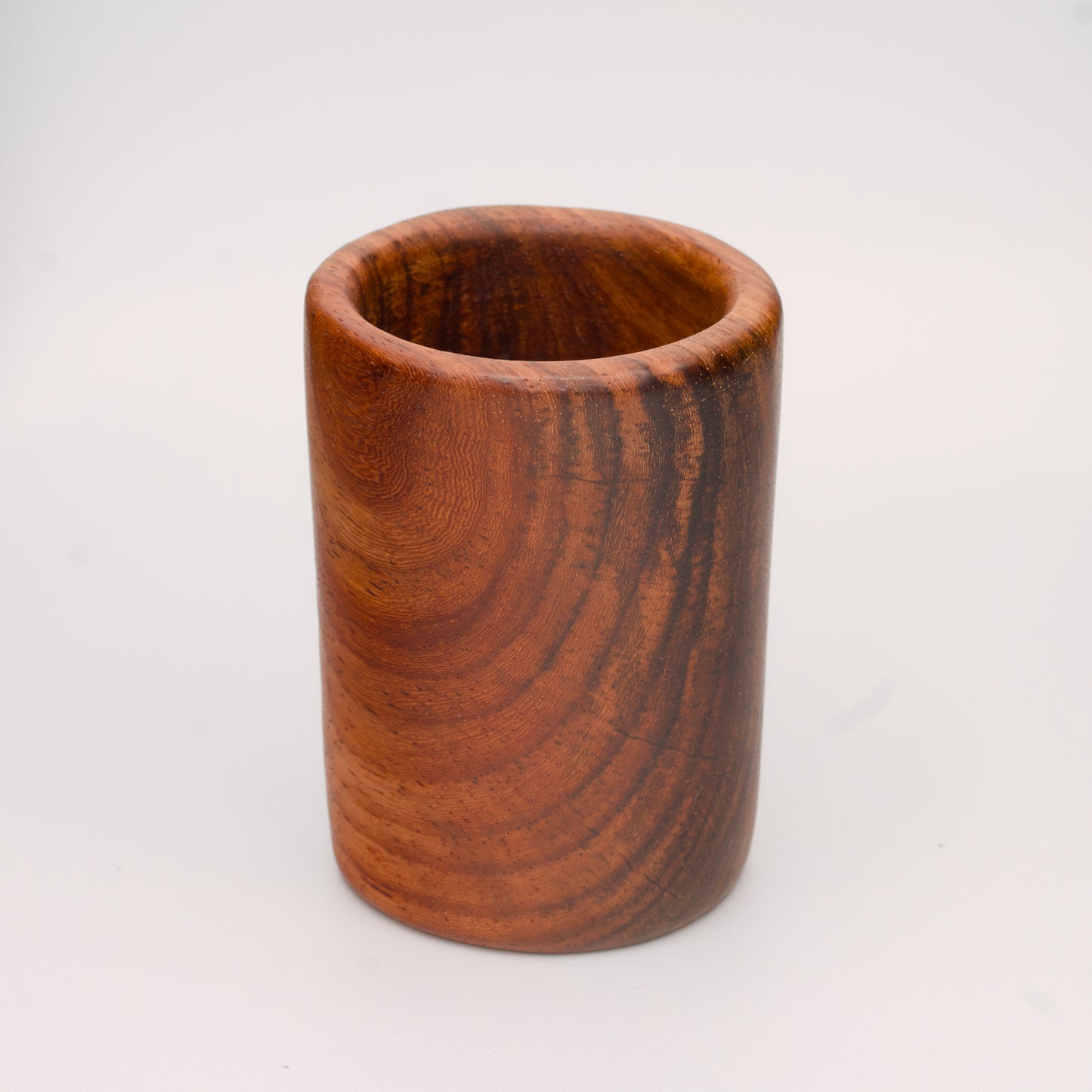 hand made wooden shot glass with golden brown tones