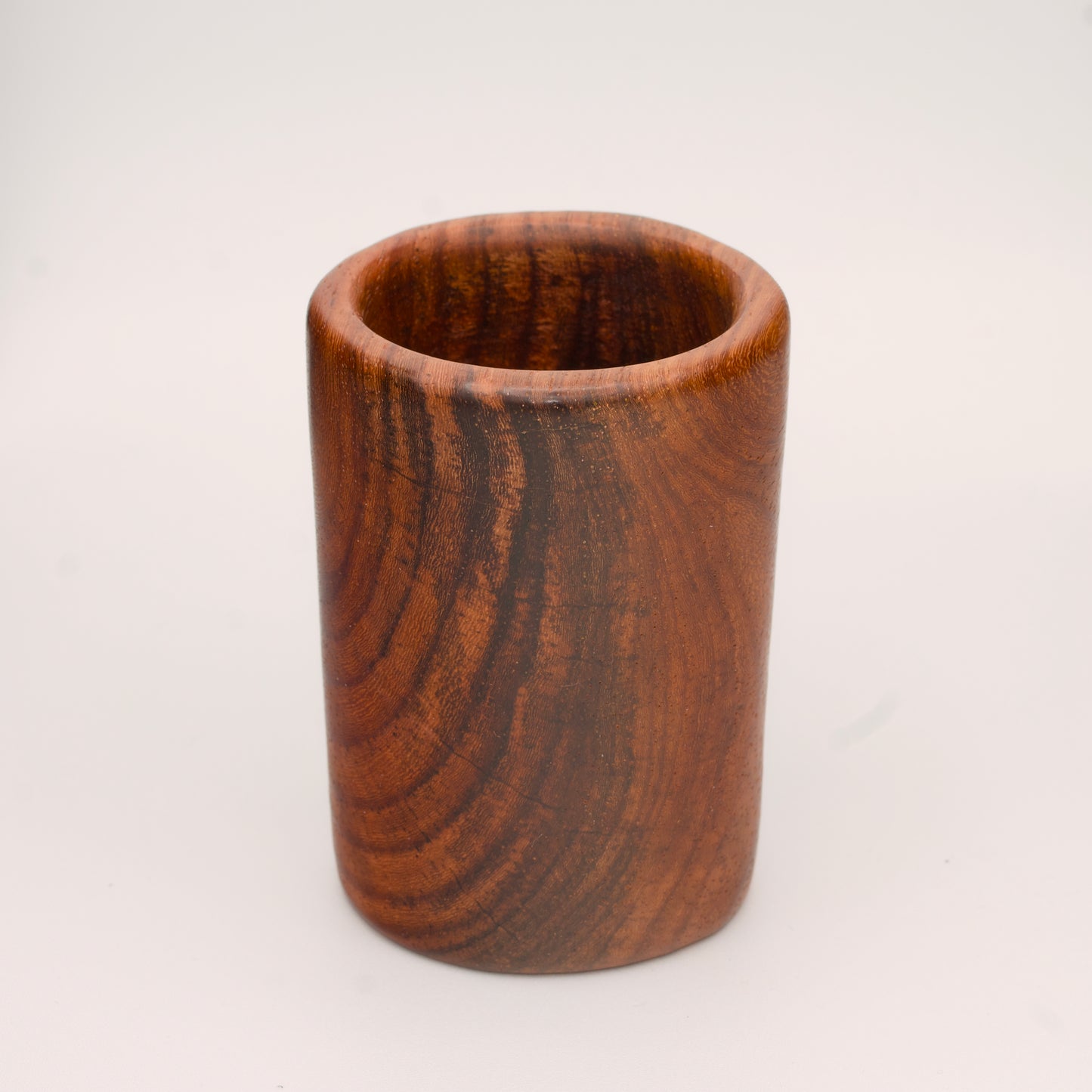 hand made wooden shot glass with golden brown tones 