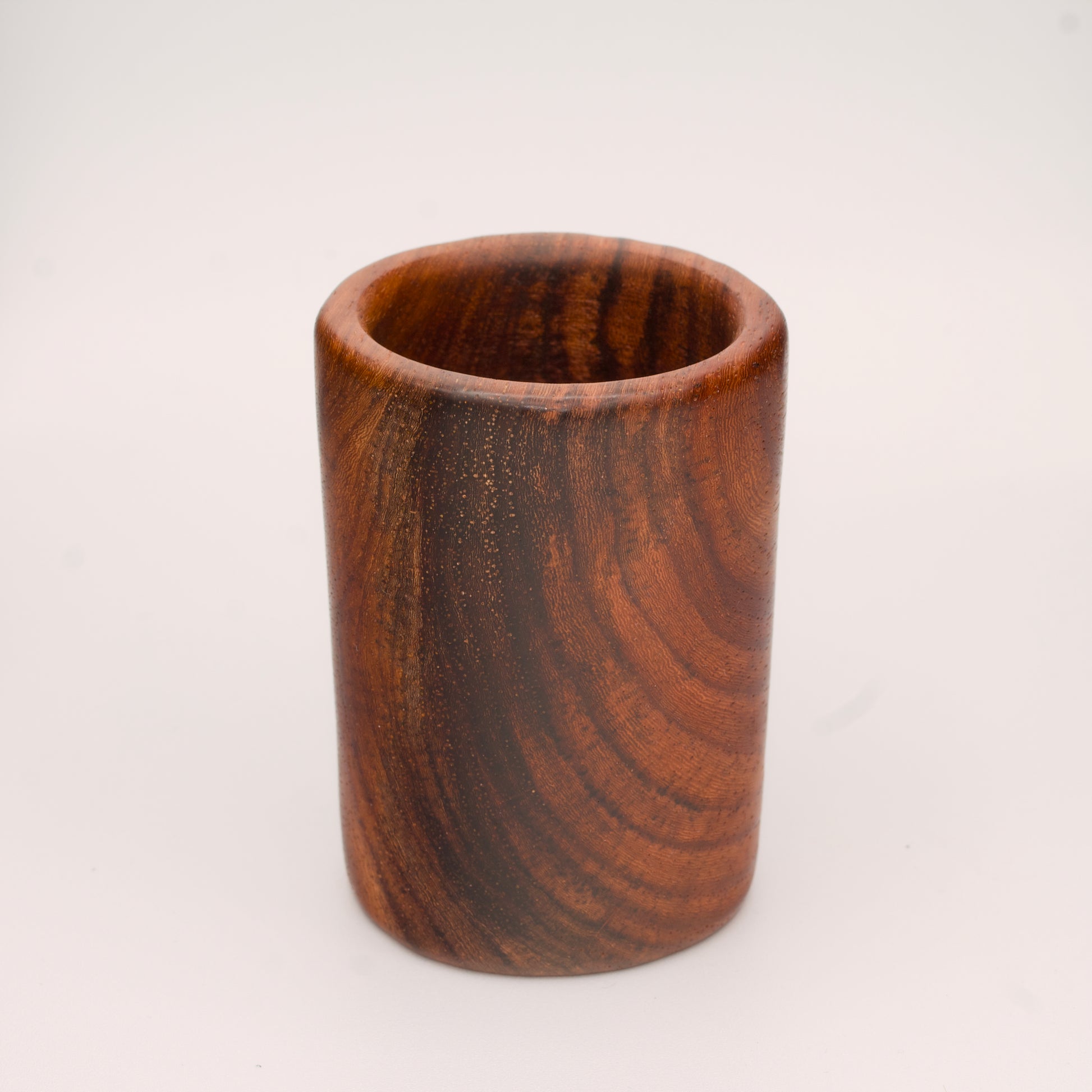 hand made wooden shot glass with golden brown tones 