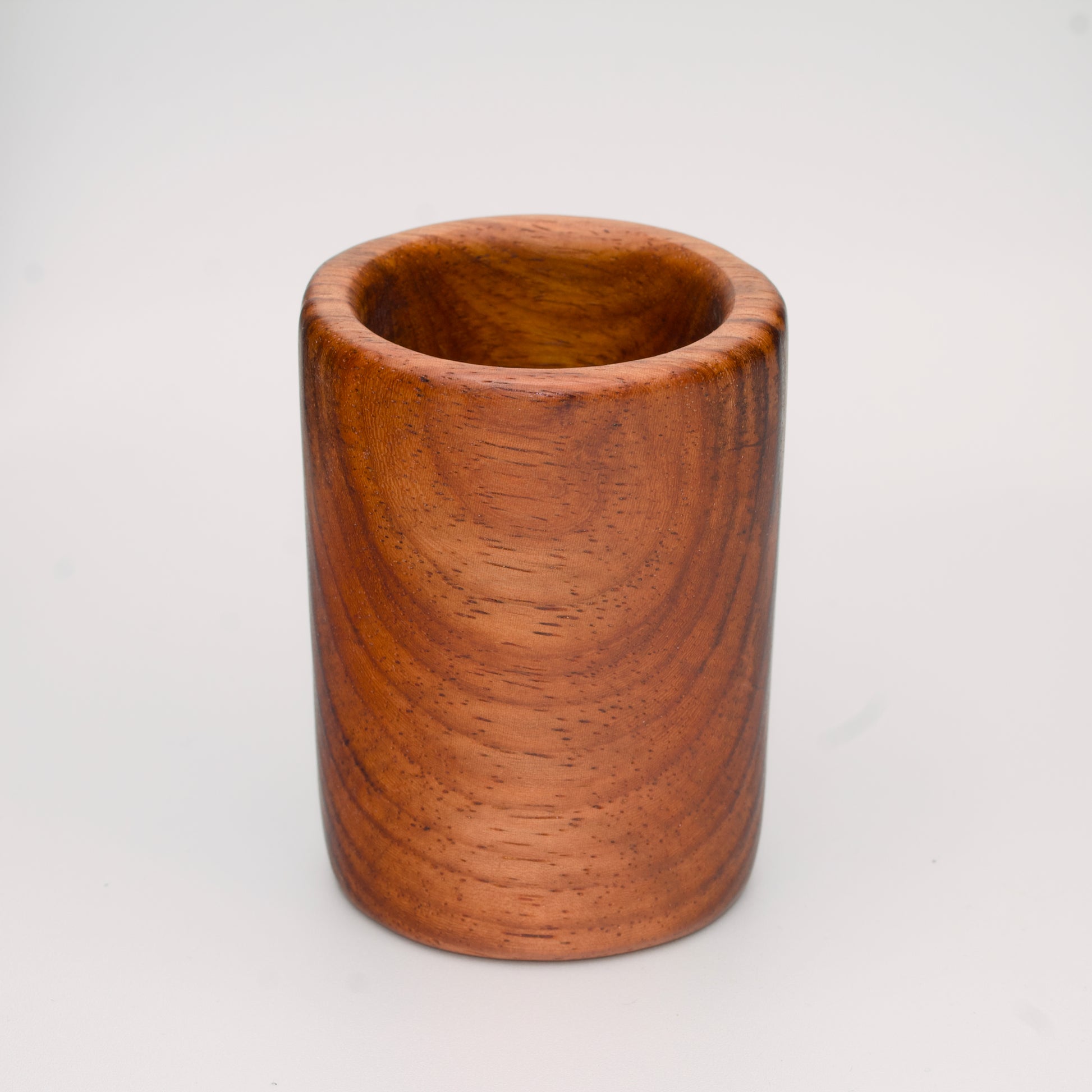 hand made wooden shot glass with golden brown tones 
