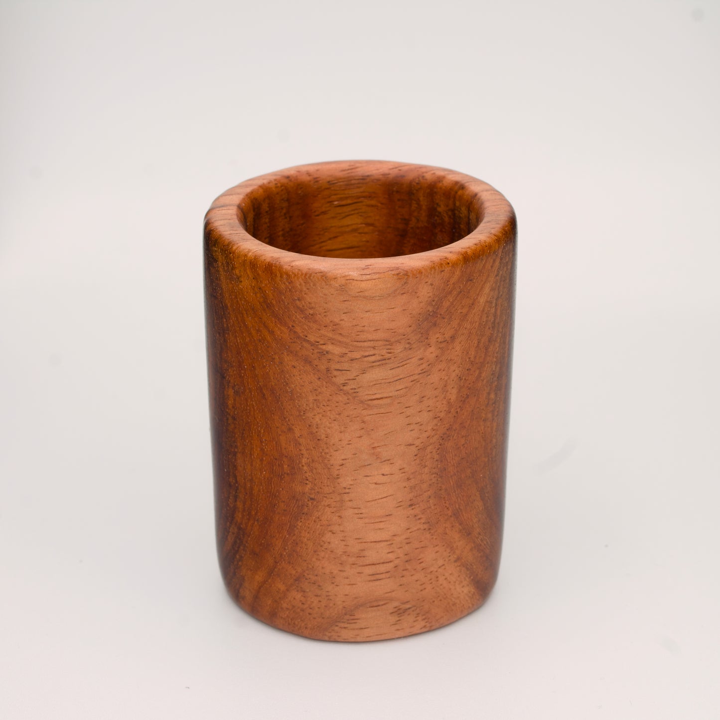 hand made wooden shot glass with golden brown tones 