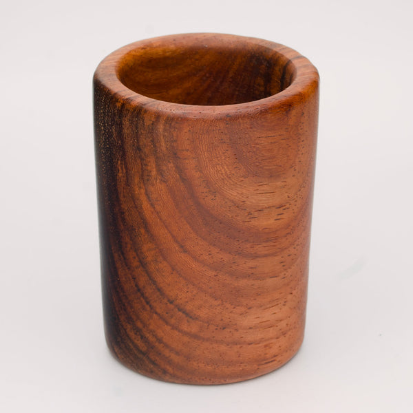 hand made wooden shot glass with golden brown tones 
