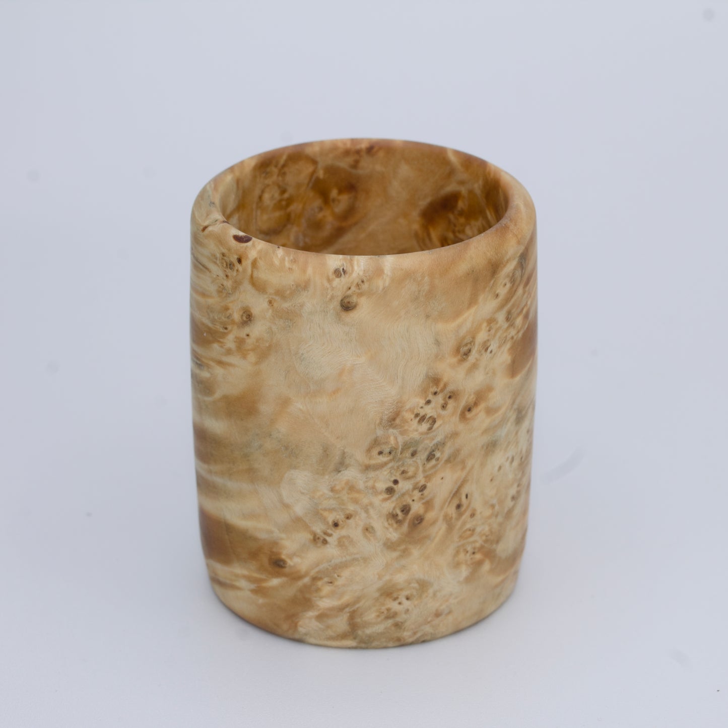 Box Elder burl wood shot glass against white background