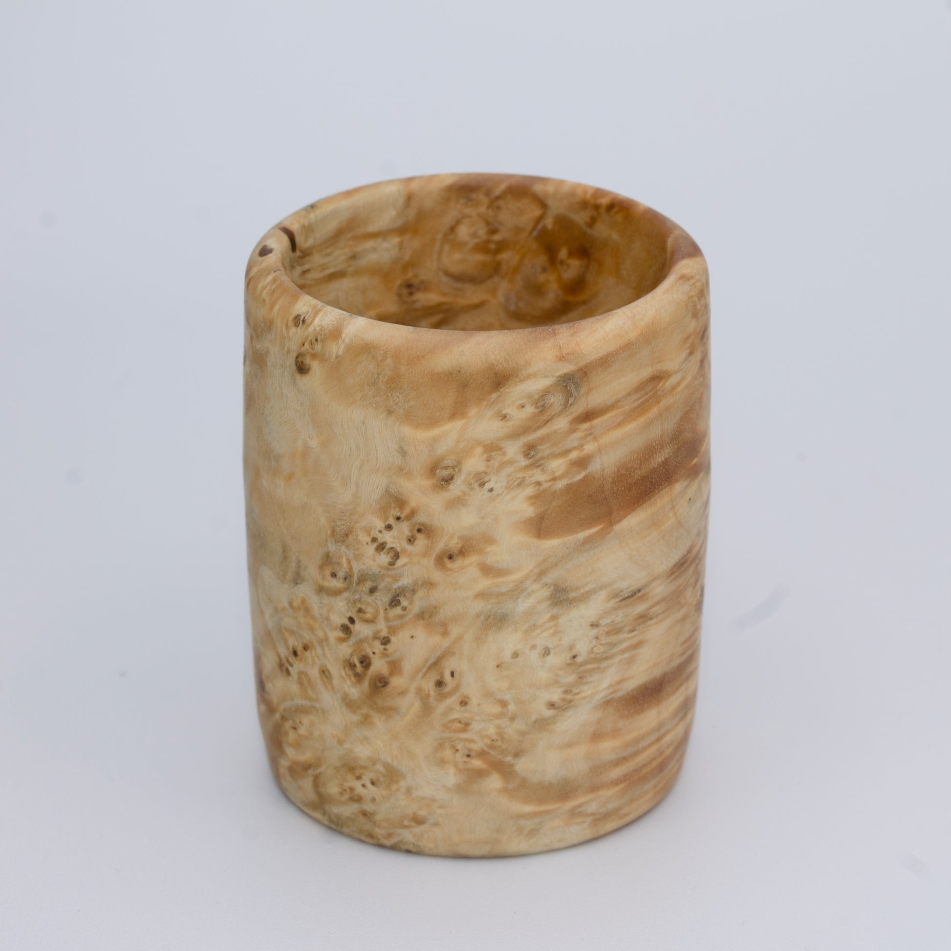 Box Elder burl wood shot glass against white background