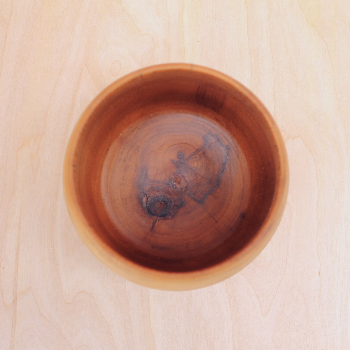 Wooden bowl on a light wooden surface
