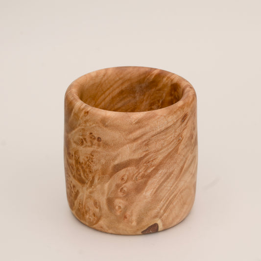 Maple burl wood shot glass on white background