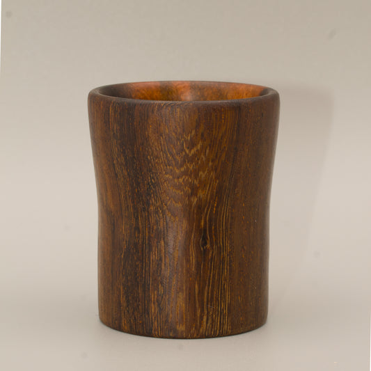 Wooden cup with a dark brown finish on a grey  background