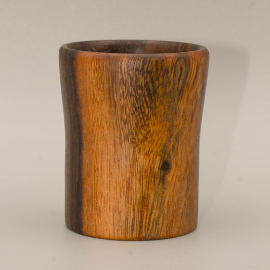 Wooden cup with a dark brown finish on a grey  background