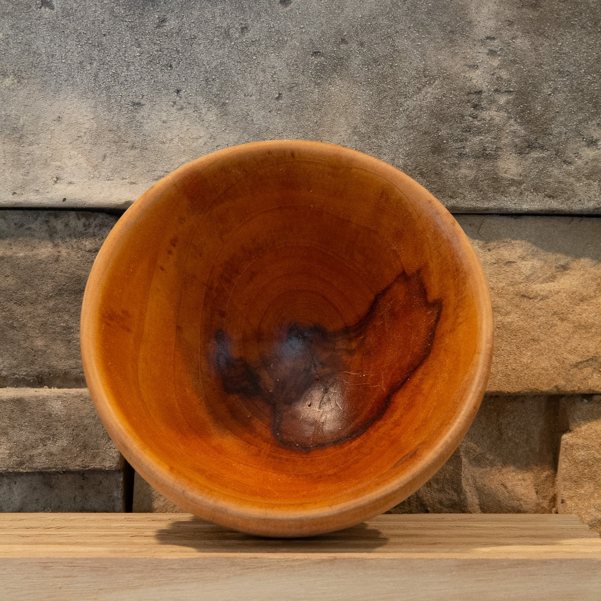 Interior of The Wood at Hand recovered hardwood rice bowl showing concentric end grain and dark natural figure