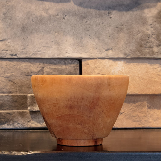 The Wood at Hand recovered hardwood rice bowl showing warm grain across its tapered profile and raised foot