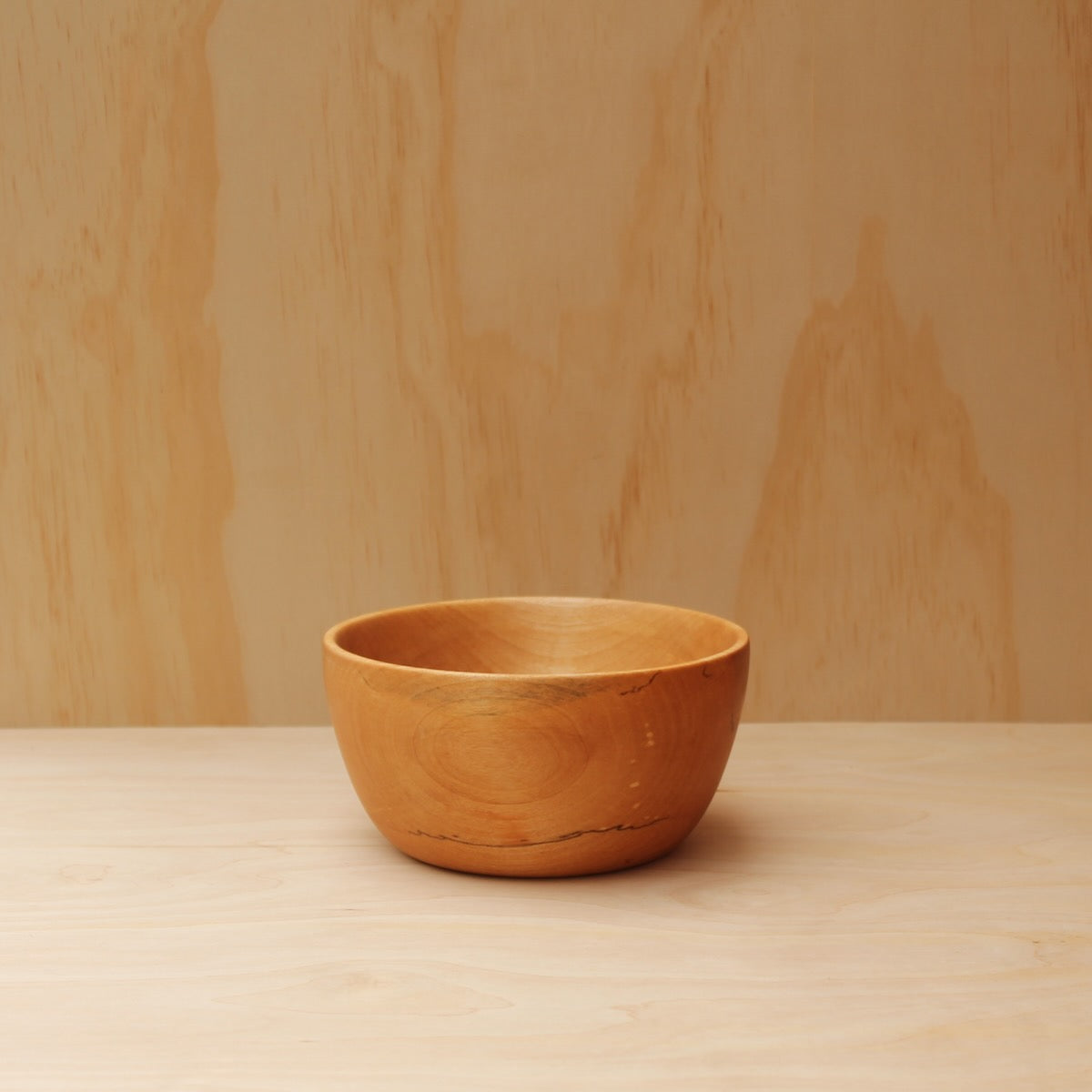 food safe wooden soup bowl on a light wood background