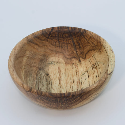 Wooden bowl with a natural finish on a white background