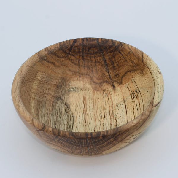 Wooden bowl with a natural finish on a white background