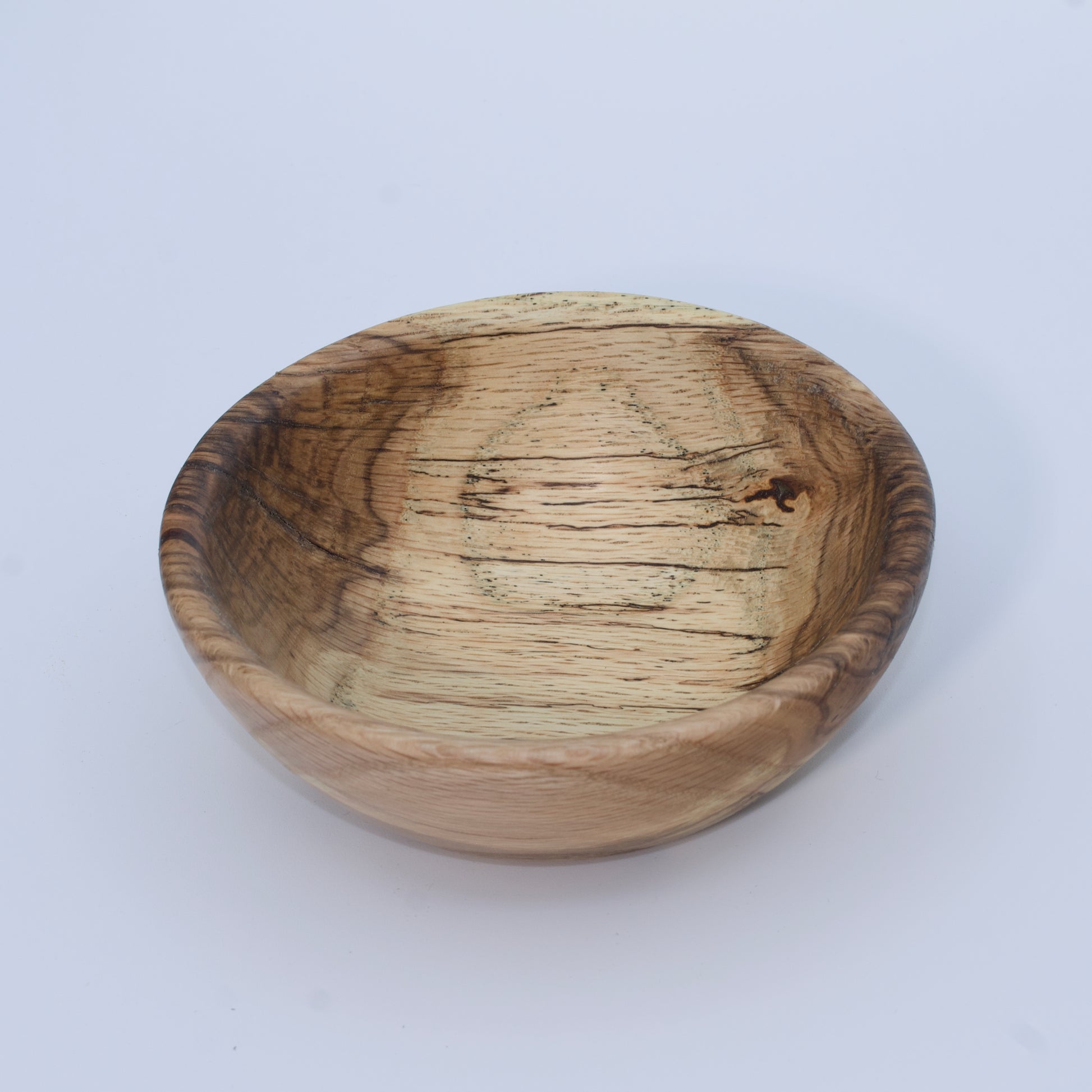 Wooden bowl with a natural finish on a white background