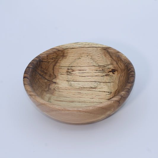 Wooden bowl with a natural finish on a white background